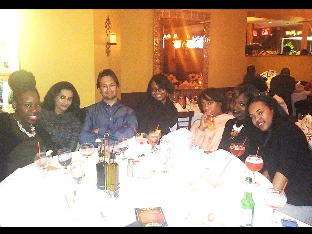 Staff smiling at table